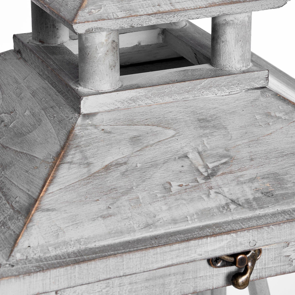 Close-up of Hill Interiors grey wooden lantern showing the pagoda-style tiered roof, weathered painted finish, and small brass latch on the hinged door.