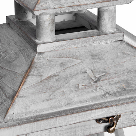 Close-up of Hill Interiors grey wooden lantern showing the pagoda-style tiered roof, weathered painted finish, and small brass latch on the hinged door.