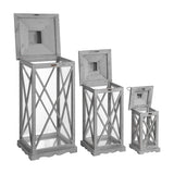 Hill Interiors set of three wooden lanterns in grey with cross-section glazed panels and hinged tops open, shown in graduated heights on a white background.