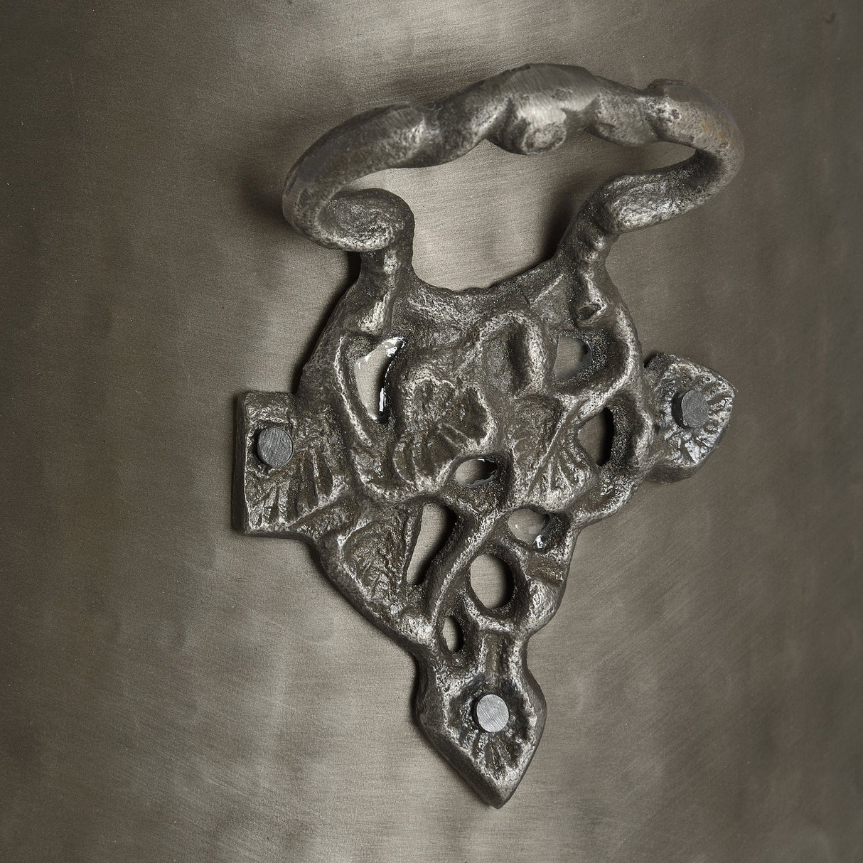 Close-up of Hill Interiors Antique Pewter Coal Bucket showing the ornate cast metal mount and twisted swing handle in a soft silver finish.