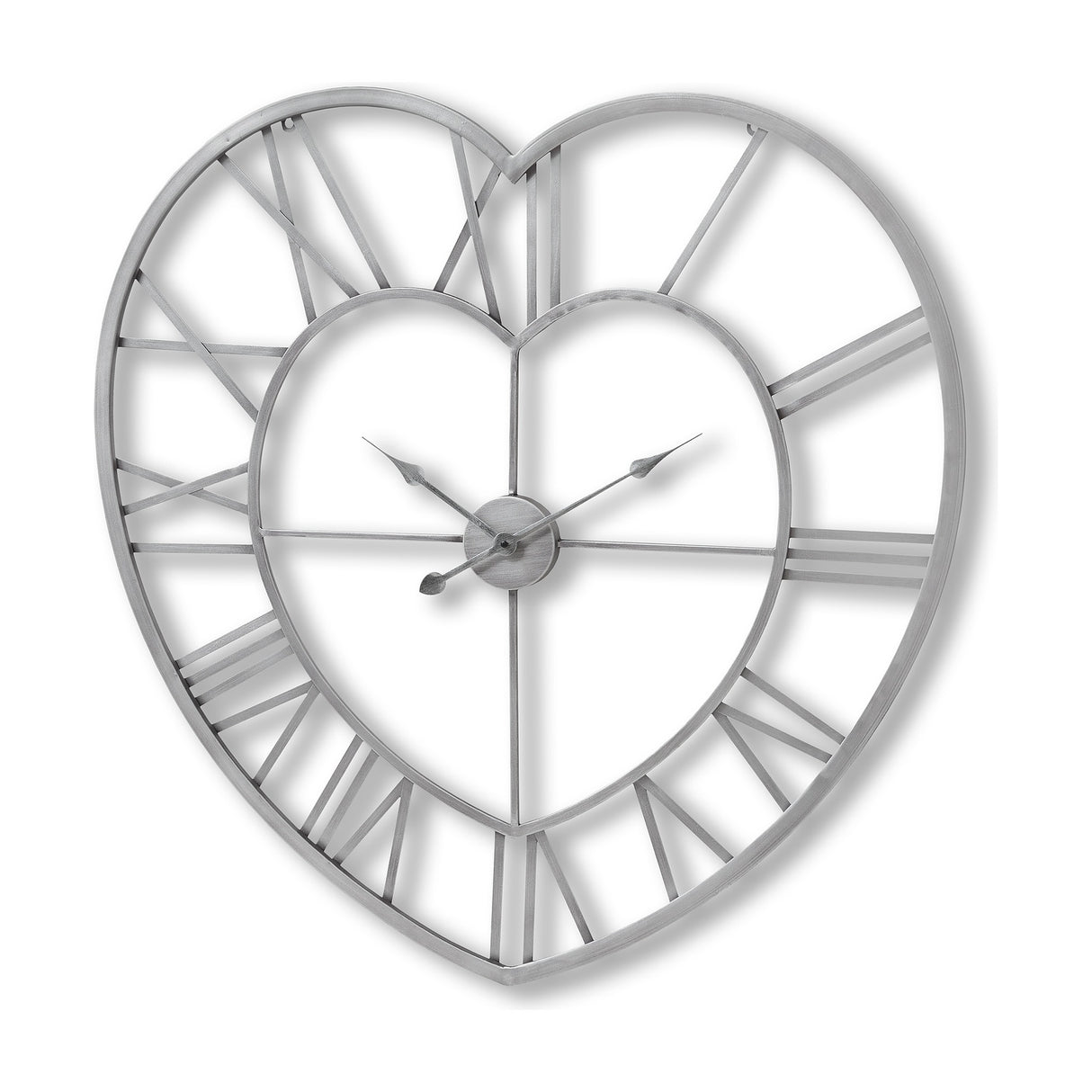 Hill Interiors Skeleton Heart Wall Clock in silver metal, with openwork heart-shaped frame, Roman numerals and exposed hands on a white background.