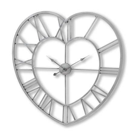 Hill Interiors Skeleton Heart Wall Clock in silver metal, with openwork heart-shaped frame, Roman numerals and exposed hands on a white background.