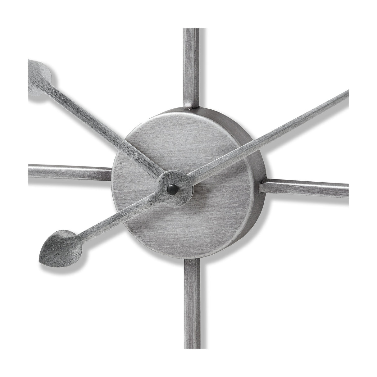 Close-up of Hill Interiors Skeleton Heart Wall Clock in silver, showing the central metal disc, slim hands and spoke-like arms of the openwork frame.