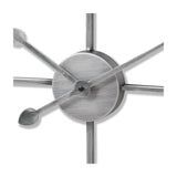Close-up of Hill Interiors Skeleton Heart Wall Clock in silver, showing the central metal disc, slim hands and spoke-like arms of the openwork frame.