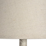 Close-up of the natural linen drum shade and grey turned wood base of the Hill Interiors Wooden Table Lamp.