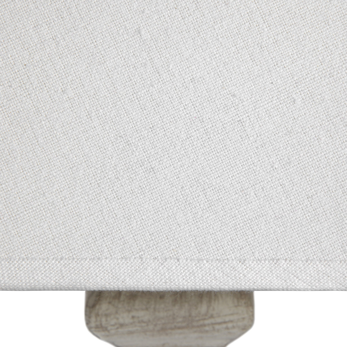 Close-up of the Hill Interiors Wooden Table Lamp in White, showing the woven linen shade and turned wood base with a soft white finish.