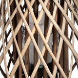 Close-up of Hill Interiors Large Bulbous Wicker Lantern in brown, showing the diamond-woven rattan strands around a glass insert holding a pillar candle.