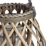 Close-up of Hill Interiors Small Bulbous Wicker Lantern in brown, showing the woven rim, braided trim, glass candle insert and open lattice weave.
