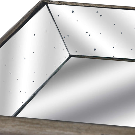 Close-up of Hill Interiors Distressed Mirrored Tray with wooden trim in silver, showing the antique-style speckled mirror surface and angled corner detail.