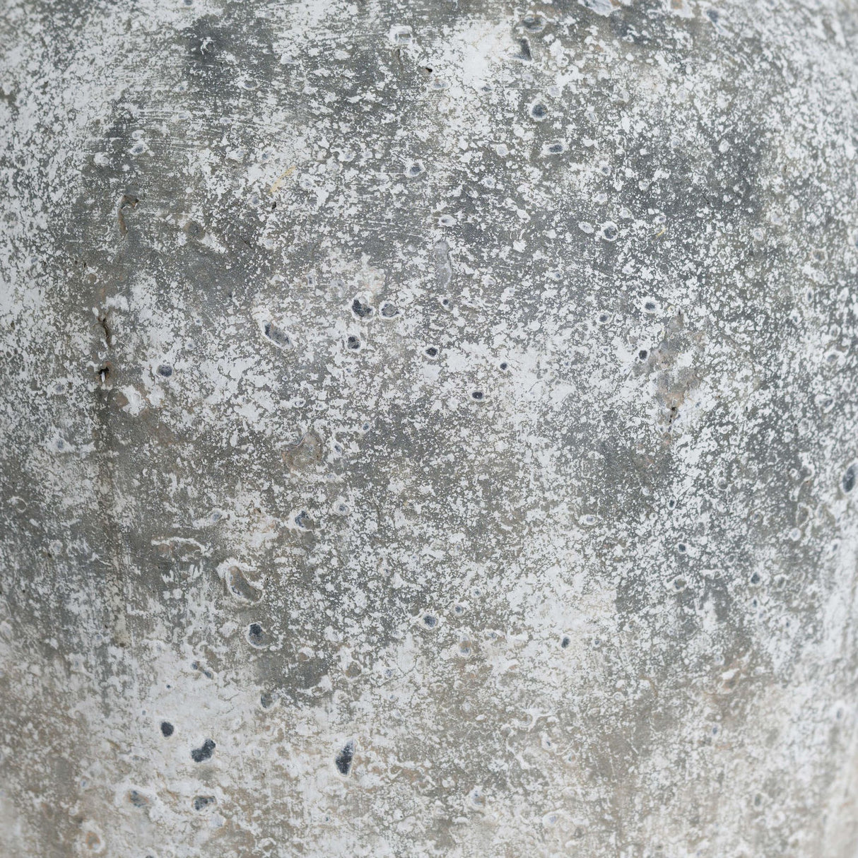 Close-up of the Hill Interiors Aged Stone Ceramic Vase in beige, showing the mottled, matte stone-effect finish with grey and white weathered texture.