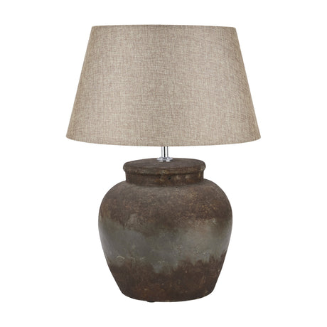 Hill Interiors Aged Stone Ceramic Table Lamp in beige with a rounded weathered urn-shaped base and tapered woven fabric shade on a white background.