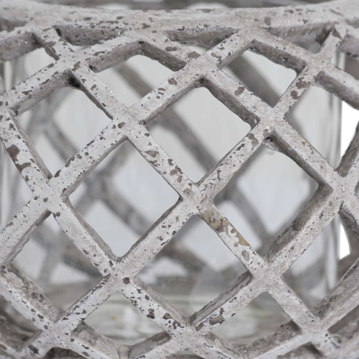 Close-up of the Hill Interiors Round Ceramic Lattice Hurricane Lantern in beige, showing the matte chalky glaze and diamond cut-out lattice pattern.