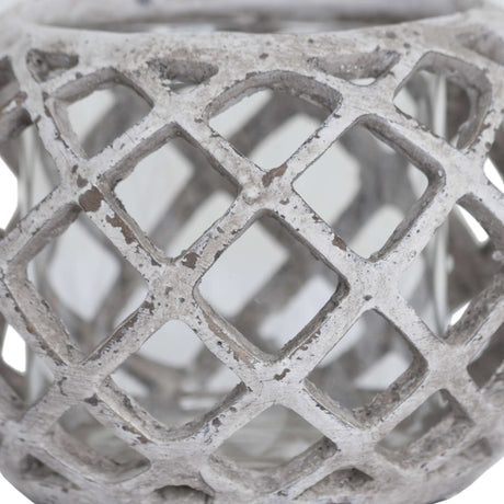 Close-up of the Hill Interiors Large Round Ceramic Lattice Hurricane Lantern in beige, showing the pierced diamond cut-outs and matte textured surface.