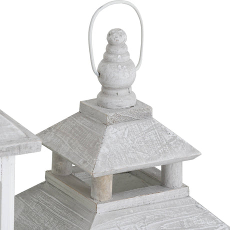 Close-up of Hill Interiors white window style lantern top with tiered wooden roof, turned finial and metal loop handle in a distressed whitewashed finish.