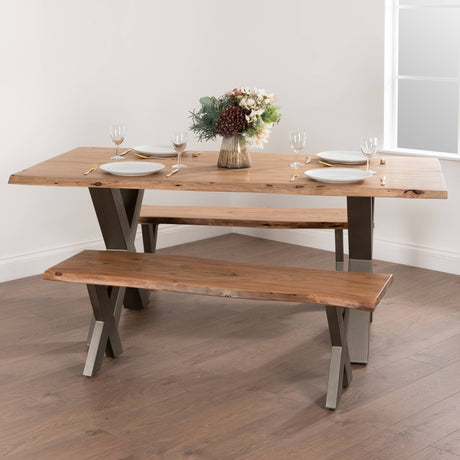 Hill Interiors Live Edge Wooden Bench in brown solid wood with organic curved edges and X-shaped metal legs, styled with a matching dining table set for four.