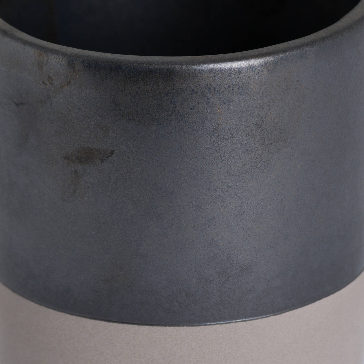 Close-up of Hill Interiors Metallic Ceramic Serving Tray in grey, showing its cylindrical form and mottled metallic glaze on a pale background.