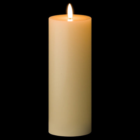 Hill Interiors LED cream wax pillar candle from the 20cm set of three, lit with a flickering flame against a black background.