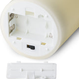 Close-up of the base of a Hill Interiors LED cream wax pillar candle showing the AA battery compartment, on/off/timer switch and removable white cover.