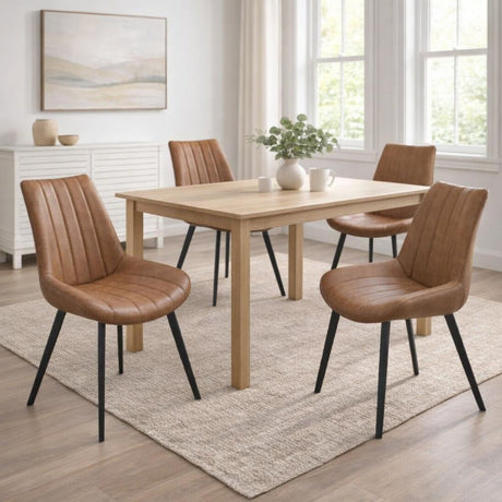 Four Hill Interiors Draxinby brown faux-leather dining chairs with black legs around a light oak table in a bright dining room with framed art.