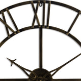 Close-up of Hill Interiors Small Antique Brass Skeleton Wall Clock showing riveted metal frame, Roman numerals and slim pointers in aged brass finish.