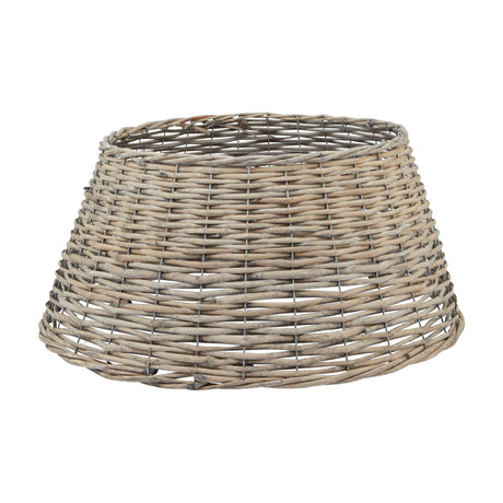 Hill Interiors wicker Christmas tree skirt in warm brown, hand-woven with a tapered round form, shown against a plain white background.