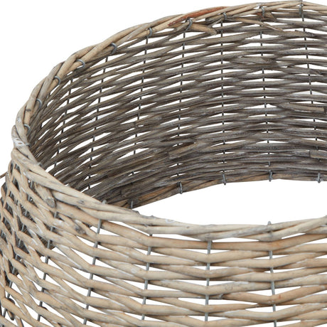 Close-up of the Hill Interiors Wicker Christmas Tree Skirt in brown, showing the hand-woven natural wicker weave and curved rim against a white background.