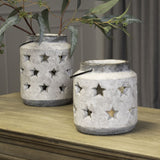 Hill Interiors Large Stone Star Lantern ceramic candle holders in beige with pierced star cut-outs and wire handles, styled with foliage on a wooden sideboard.
