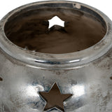 Close-up of Hill Interiors Small Star Tea Light Lantern in silver, showing the ceramic body's distressed metallic finish and pierced star cut-outs.