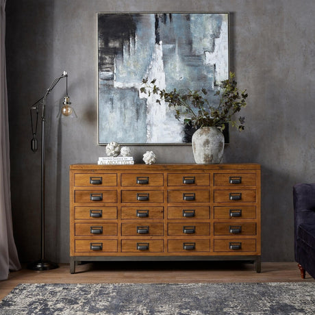 Hill Interiors medium white resin artichoke ornament styled on a wooden chest of drawers beneath abstract art, beside a floor lamp and vase of foliage.