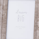 Close-up of the Hill Interiors Convex Matt Silver 5x7in photo frame, showing its wood body with weathered silver finish around a "dream big" insert.