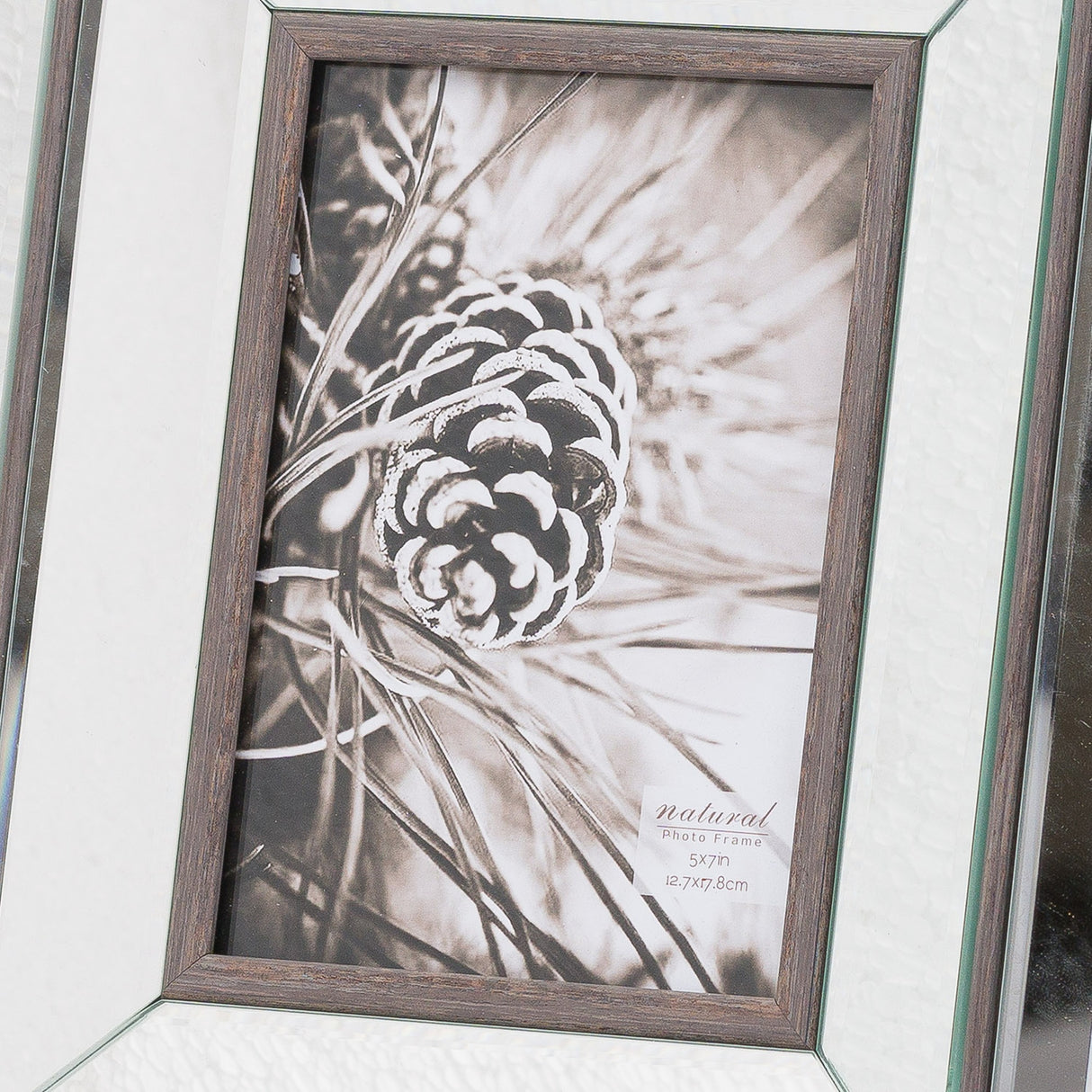 Hill Interiors 5x7in photo frame with brown wooden surround and mirrored border, displaying a black and white pinecone image in portrait.