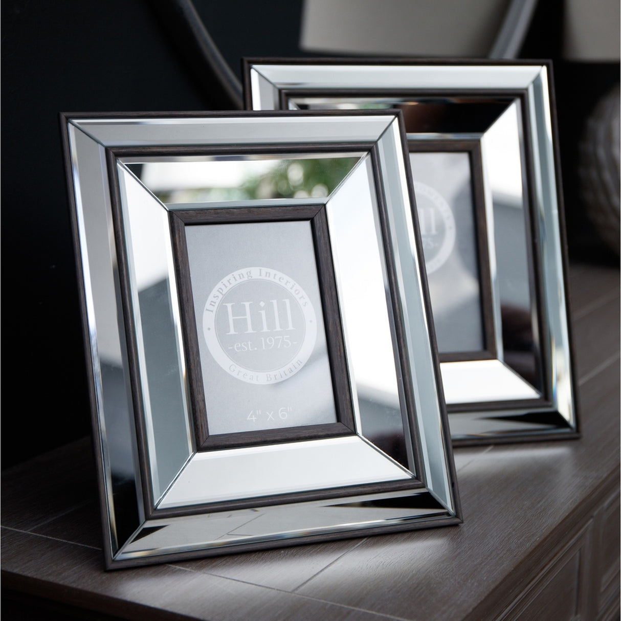 Hill Interiors Mirror and Wood Photo Frame 5x7in in brown, two rectangular frames with mirrored borders and wooden inner surrounds displayed on a dark console.