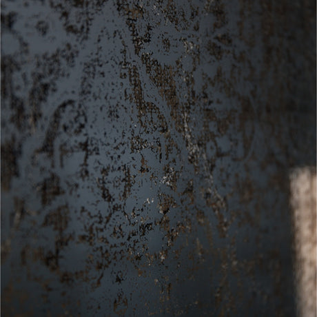 Close-up of the Hill Interiors Antique Foxed Wall Mirror in bronze, showing the mottled, speckled patina across the aged glass surface.