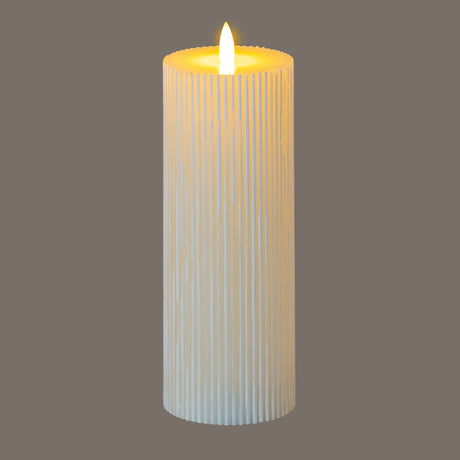 Hill Interiors Textured Ribbed LED Pillar Candle in beige with a lit flame-effect tip, shown against a plain grey background.