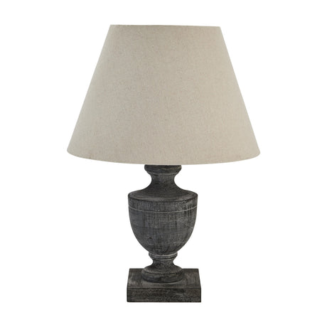 Hill Interiors Ondelle Urn Wooden Table Lamp in brown with a turned urn base, square plinth and tapered neutral linen shade on a white background.