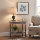 Hill Interiors Ondelle Urn Wooden Table Lamp in brown with tapered cream shade, lit on a grey side table beside an armchair and framed coral print.