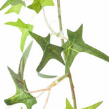 Close-up of Hill Interiors Small Faux Ivy Garland showing pointed green plastic leaves and slim flexible stems against a plain white background.
