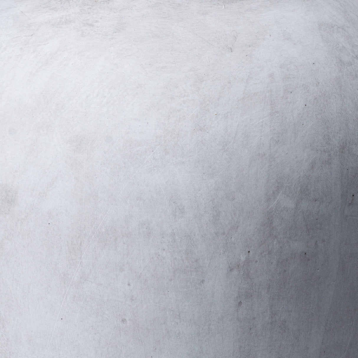 Close-up of the Hill Interiors Stone-Effect Ceramic Vase in beige, showing the matte textured surface and softly curved form.