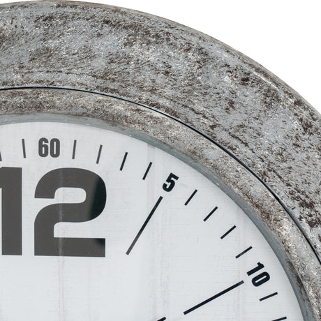 Close-up of Hill Interiors Round Glass Wall Clock in silver, showing the distressed metallic frame, glass lens, and white dial with bold black numerals.