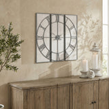 Hill Interiors Panelled Metal Wall Clock in silver, large square three-panel design with open Roman numeral dial, mounted above a wooden sideboard.