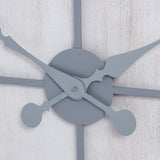 Close-up of Hill Interiors Panelled Metal Wall Clock in silver, showing the central hub with ornate hour and minute hands against a whitewashed panelled face.