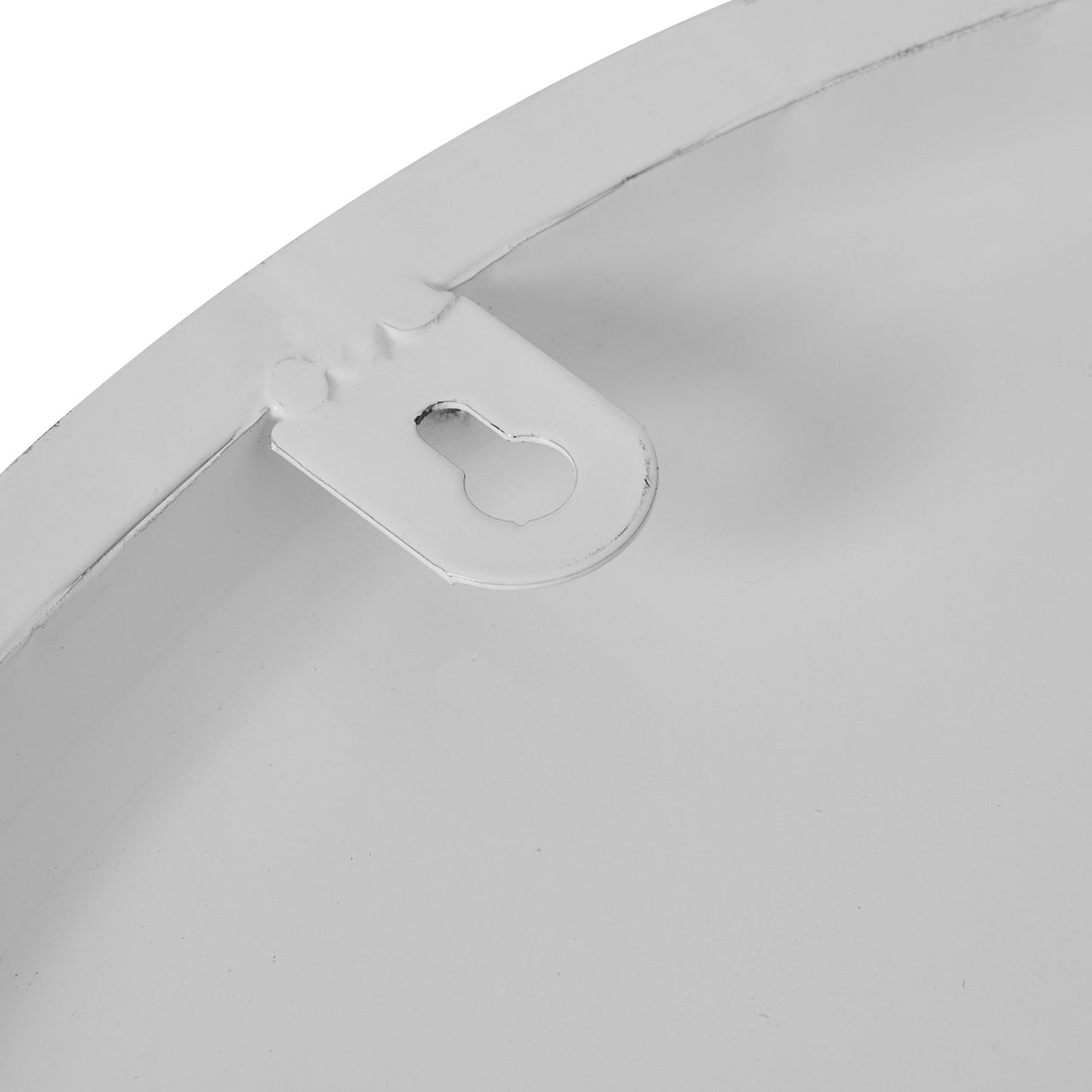 Close-up of the metal keyhole hanging bracket on the back of the Hill Interiors White Round Metal Wall Clock, showing the white finish.