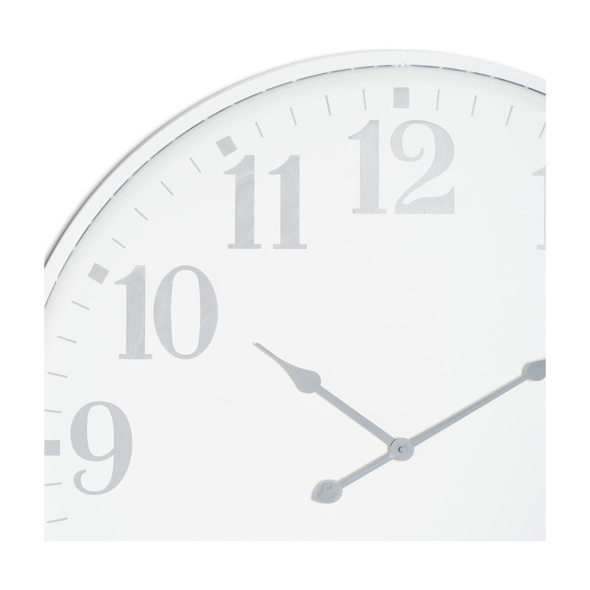 Close-up of the Hill Interiors Large Round Metal Wall Clock in white, showing the upper left face with grey numerals 9 to 12 and slim hands.