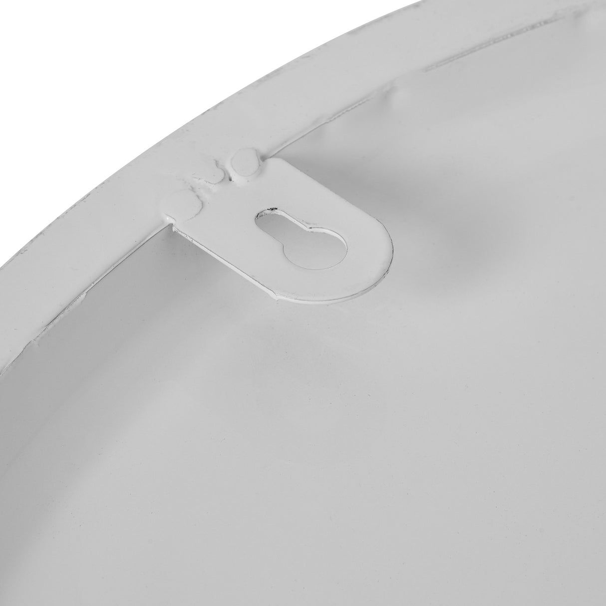 Close-up of the metal rear edge of the Hill Interiors Round Metal Wall Clock in white, showing the keyhole hanging bracket on the curved frame.