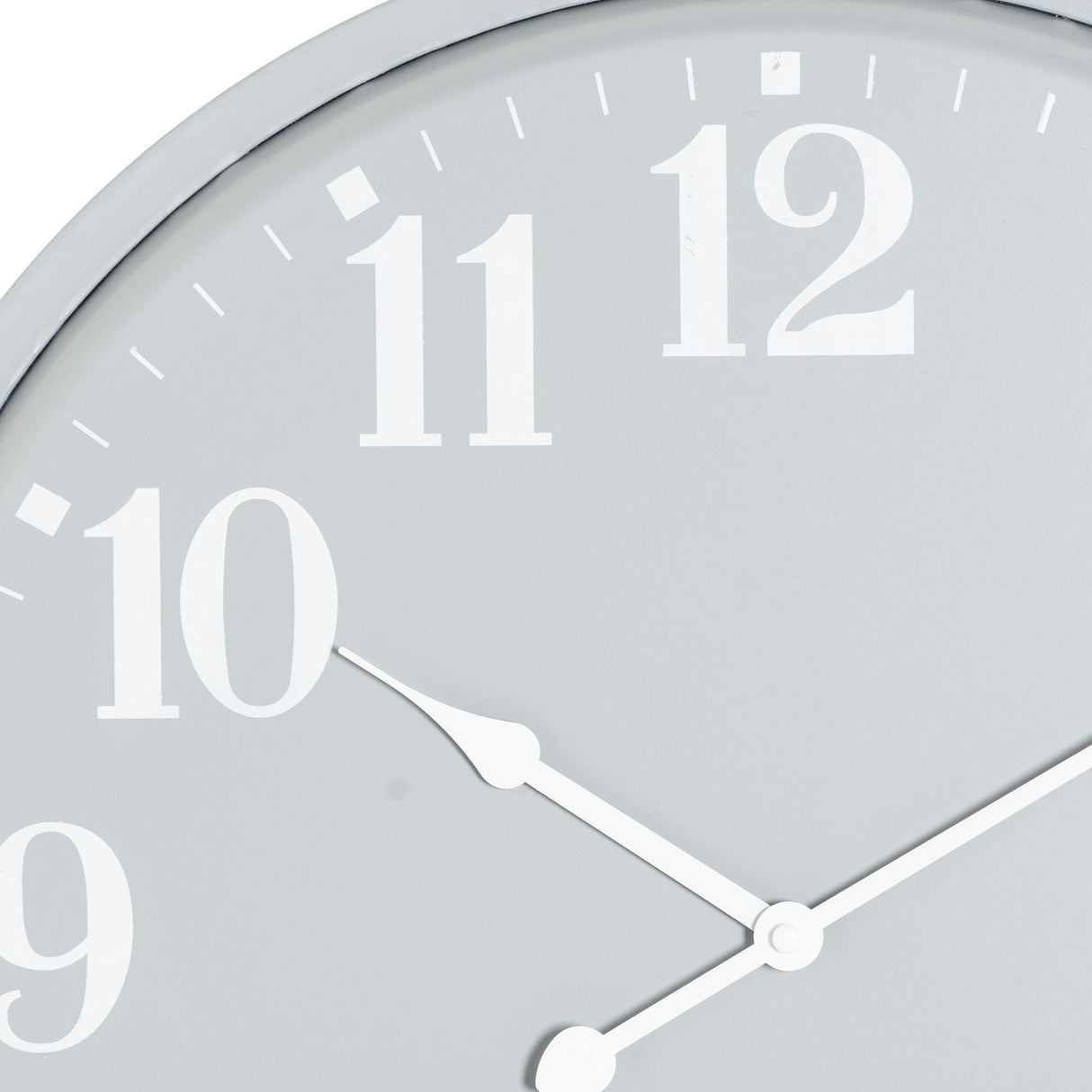 Close-up of Hill Interiors Round Metal Wall Clock in grey, showing white numerals 9 to 12 and slim white hands on a soft grey dial.