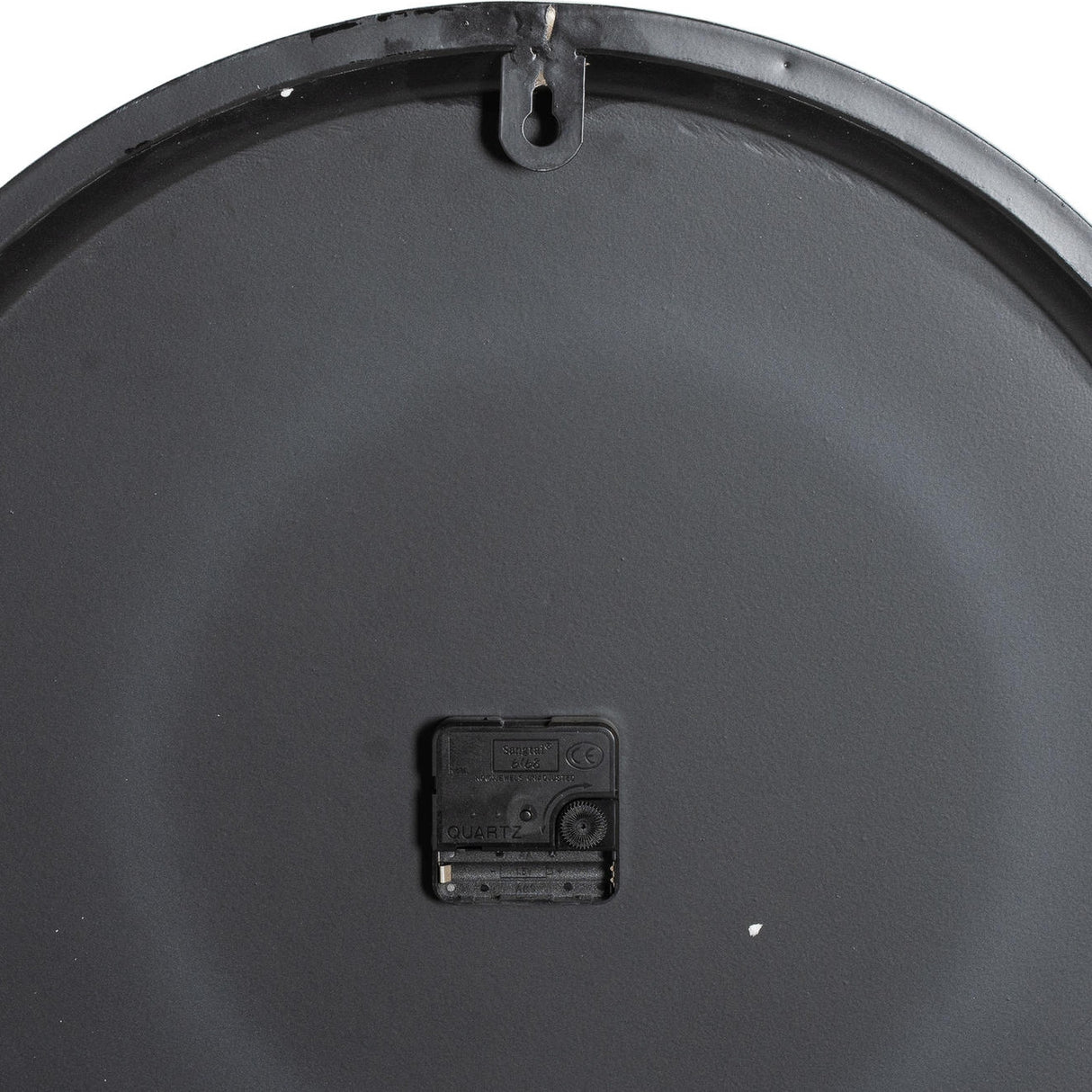Rear view of Hill Interiors Round Metal Wall Clock in grey, showing the quartz movement housing and single keyhole hanging slot on the metal back.