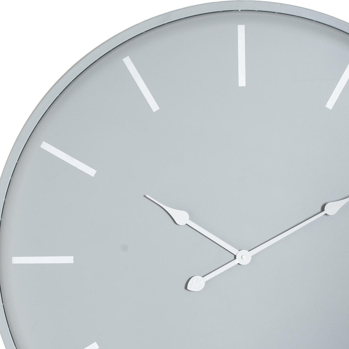 Close-up of Hill Interiors Large Round Metal Wall Clock in grey, showing slim white hands and rectangular hour markers on a pale dial.