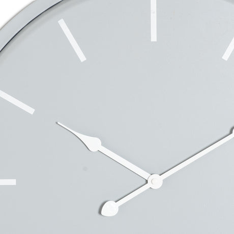 Close-up of the Hill Interiors Round Metal Wall Clock in grey, showing white baton markers and slim white hour and minute hands on a soft grey dial.