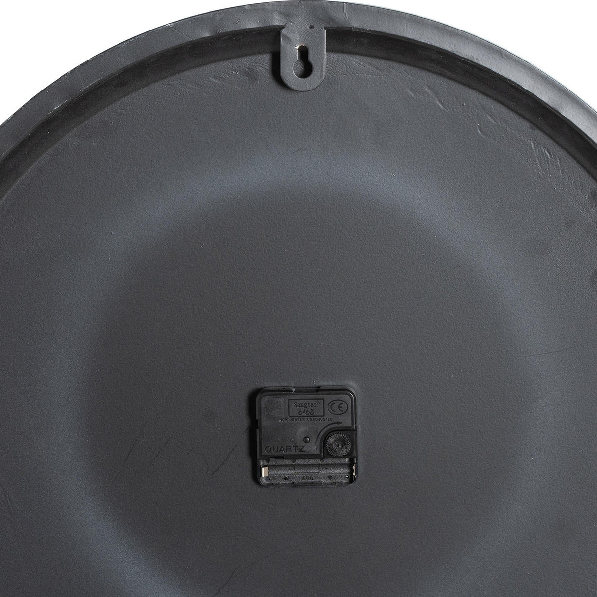 Back of Hill Interiors Round Metal Wall Clock in grey, showing the keyhole hanger at the top and central quartz movement housing.