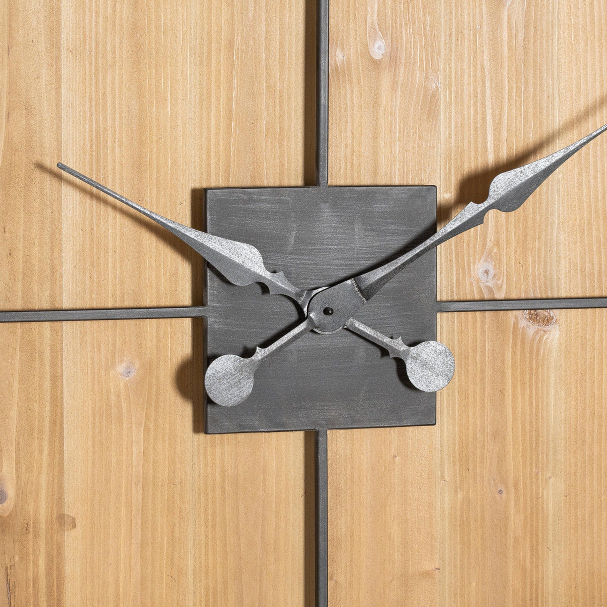 Close-up of Hill Interiors Large Square Wooden Wall Clock in brown, showing ornate silver metal hands on a square central plate against wood-effect panels.